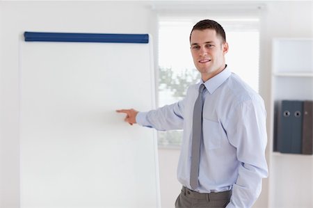 professionals whiteboard - Confident young businessman giving a presentation Stock Photo - Budget Royalty-Free & Subscription, Code: 400-05710357