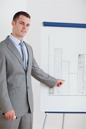 professionals whiteboard - Young businessman pointing at chart Stock Photo - Budget Royalty-Free & Subscription, Code: 400-05710380