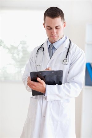 simsearch:400-05710928,k - Doctor having a close look at his notes Stockbilder - Microstock & Abonnement, Bildnummer: 400-05710399