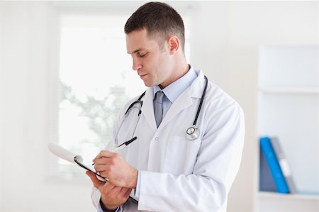 simsearch:400-05710928,k - Young doctor taking notes carefully Stockbilder - Microstock & Abonnement, Bildnummer: 400-05710406