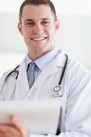 simsearch:400-05710928,k - Close up of smiling young doctor with his notes Stockbilder - Microstock & Abonnement, Bildnummer: 400-05710402