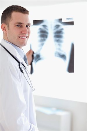 simsearch:400-05710928,k - Smiling young doctor with x-ray image Stockbilder - Microstock & Abonnement, Bildnummer: 400-05710443