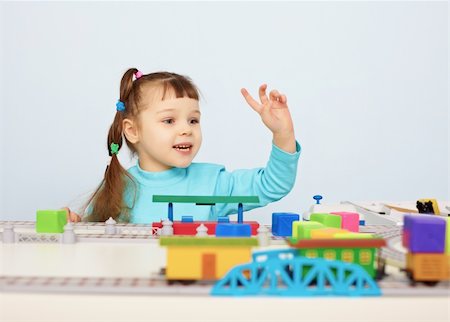 simsearch:400-05292821,k - A child plays with a toy railroad on table Stock Photo - Budget Royalty-Free & Subscription, Code: 400-05710899