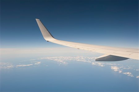 View from a large aircraft in flight with the wing against a blue sky background Stock Photo - Budget Royalty-Free & Subscription, Code: 400-05710907