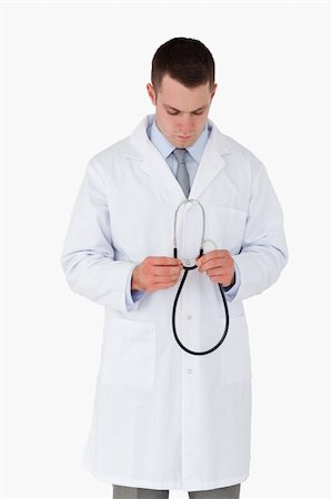 simsearch:400-05710928,k - Doctor looking at his stethoscope on white background Stockbilder - Microstock & Abonnement, Bildnummer: 400-05710958