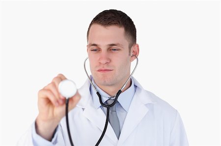 simsearch:400-05710928,k - Close up of doctor looking at his stethoscope while using it on white background Stockbilder - Microstock & Abonnement, Bildnummer: 400-05710967