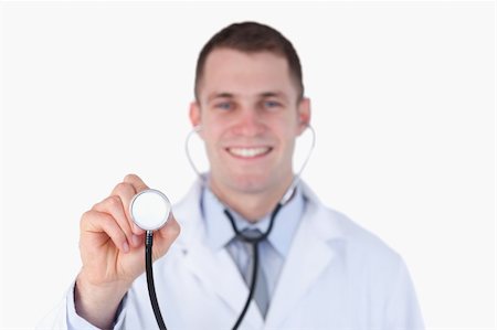 simsearch:400-05710928,k - Close up of smiling doctor using his stethoscope on white background Stockbilder - Microstock & Abonnement, Bildnummer: 400-05710969