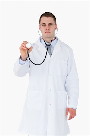 simsearch:400-05710928,k - Serious looking doctor using stethoscope on white background Stockbilder - Microstock & Abonnement, Bildnummer: 400-05710960