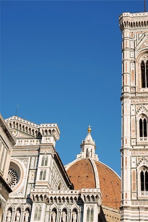 simsearch:400-05733973,k - Florence Cathedral of Santa Maria del Fiore or Duomo di Firenze, detail of the facade, Brunelleschi's dome and Giotto's bell tower against the blue sky. Stock Photo - Budget Royalty-Free & Subscription, Code: 400-05711101