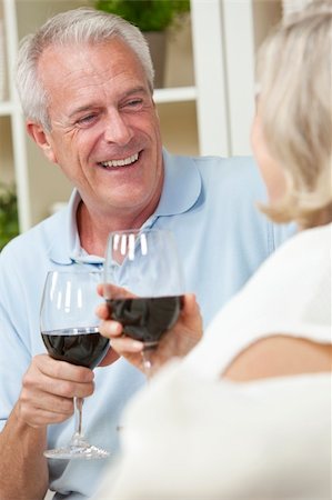 Happy senior man and woman couple sitting together at home smiling and drinking wine Stock Photo - Budget Royalty-Free & Subscription, Code: 400-05711209