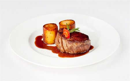 restaurant steak - beef filet with fondant potato and red wine sauce on a white plate Stock Photo - Budget Royalty-Free & Subscription, Code: 400-05711461
