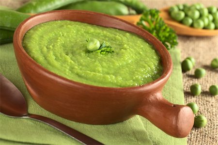 Fresh green pea soup in rustic bowl (Selective Focus, Focus on the pea and the parsley leaf in the middle of the soup) Stock Photo - Budget Royalty-Free & Subscription, Code: 400-05711697