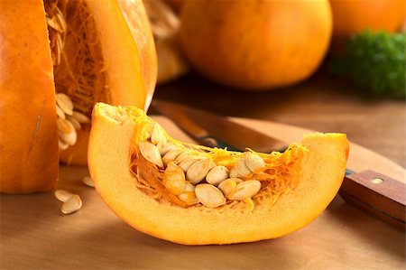 Fresh pumpkin slice with pumpkin seeds (Selective Focus, Focus on the front of the slice) Photographie de stock - Aubaine LD & Abonnement, Code: 400-05711727