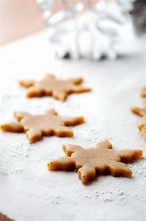 festive biscuits stars - Making gingerbread cookies for Christmas. Gingerbread dough with star shapes and a cutter. Stock Photo - Budget Royalty-Free & Subscription, Code: 400-05711736