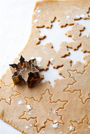 simsearch:400-07677933,k - Making gingerbread cookies for Christmas. Gingerbread dough with star shapes and a cutter. Stock Photo - Budget Royalty-Free & Subscription, Code: 400-05711733