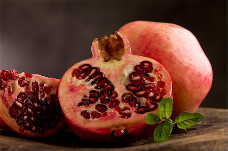 photo of sliced pomgranate in poor art style in front of rural background Stockbilder - Microstock & Abonnement, Bildnummer: 400-05711768