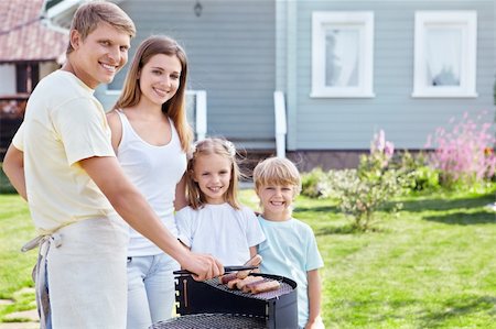 Family barbecue on the lawn Stock Photo - Budget Royalty-Free & Subscription, Code: 400-05711839