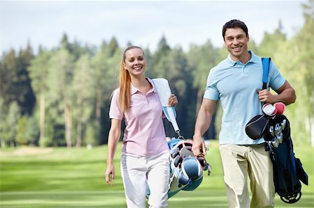 Smiling couple on the golf course Stock Photo - Budget Royalty-Free & Subscription, Code: 400-05711872