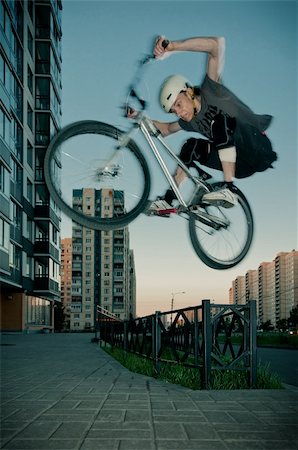 riding bike blur city - Biker jumping through fence on high speed Stock Photo - Budget Royalty-Free & Subscription, Code: 400-05712117