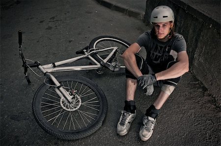 dmitryelagin (artist) - Extreme biker sitting on asphalt and relaxing Stock Photo - Budget Royalty-Free & Subscription, Code: 400-05712118