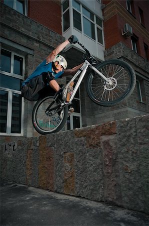 Biker standing on border after hard jump Stock Photo - Budget Royalty-Free & Subscription, Code: 400-05712120