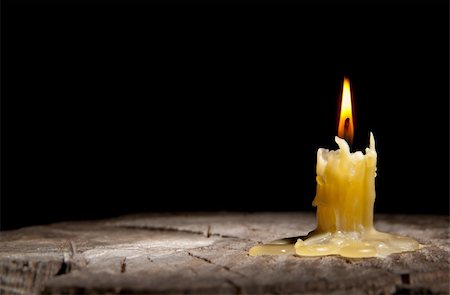 simsearch:400-06099914,k - old candle stands on the stump of a tree on the black background Stock Photo - Budget Royalty-Free & Subscription, Code: 400-05713106