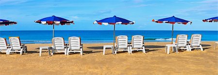 White sunbeds and umbrellas on a tropical beach - panorama Stock Photo - Budget Royalty-Free & Subscription, Code: 400-05713340