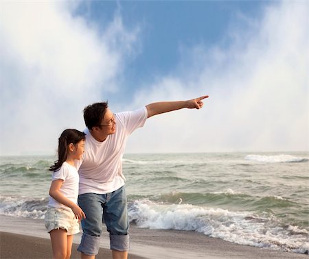 father pointing and little girl looking it on the beach Stock Photo - Budget Royalty-Free & Subscription, Code: 400-05724270