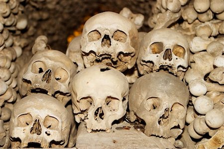 Six human skulls are piled on top of each other in the Sedlec ossuary (or bone church) located in the Czech Republic near the town Kutna Hora. A scary image for Halloween! Stock Photo - Budget Royalty-Free & Subscription, Code: 400-05725713