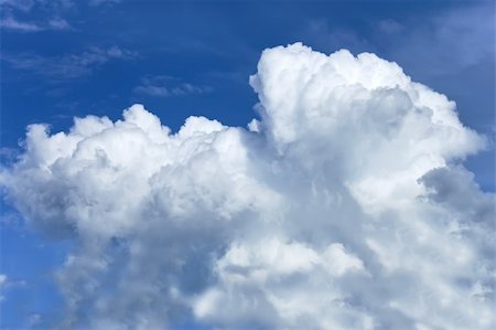 Thick white clouds against a background of a blue sky Stock Photo - Budget Royalty-Free & Subscription, Code: 400-05727479