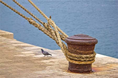 Rusty mooring bollard with ship ropes on Zadar docks Stock Photo - Budget Royalty-Free & Subscription, Code: 400-05728696