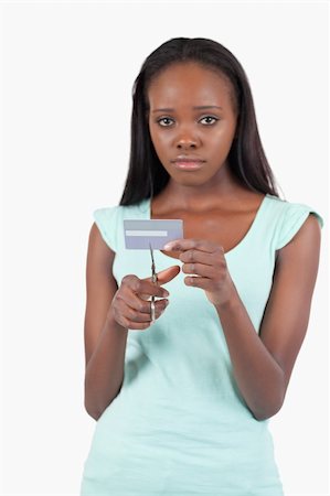 Sad woman cutting her credit card into pieces against a white background Stock Photo - Budget Royalty-Free & Subscription, Code: 400-05728786