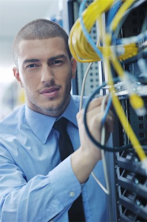 young handsome business man  engeneer in datacenter server room Stock Photo - Budget Royalty-Free & Subscription, Code: 400-05728894