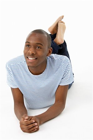 simsearch:400-04405553,k - Teenage Boy Laying On Stomach Stock Photo - Budget Royalty-Free & Subscription, Code: 400-05728906