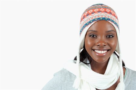 Smiling young woman with winter clothes on against a white background Stock Photo - Budget Royalty-Free & Subscription, Code: 400-05728947