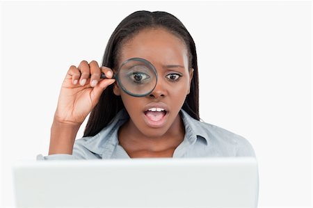 Businesswoman using a magnifying glass to look at her notebook against a white background Stock Photo - Budget Royalty-Free & Subscription, Code: 400-05729257