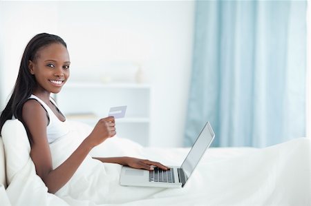 Woman shopping online in her bedroom Stock Photo - Budget Royalty-Free & Subscription, Code: 400-05729414