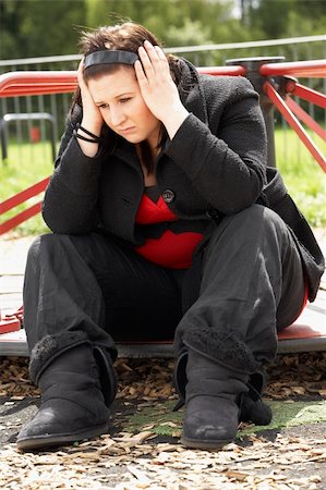 depressed woman in the street - Young Woman Sitting In Playground Stock Photo - Budget Royalty-Free & Subscription, Code: 400-05729526