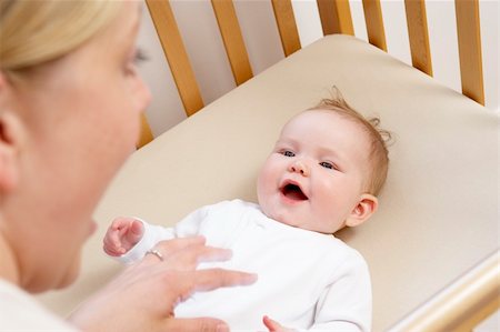Mother Playing With Baby In Cot Stock Photo - Budget Royalty-Free & Subscription, Code: 400-05729599