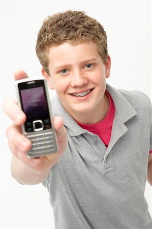 Portrait of Smiling Teenage Boy Holding Mobile Phone Stock Photo - Budget Royalty-Free & Subscription, Code: 400-05729857