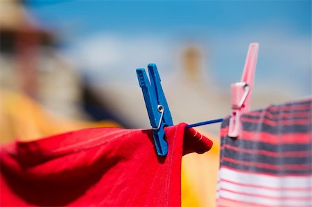 Washed clothes drying outside with cloth pegs Photographie de stock - Aubaine LD & Abonnement, Code: 400-05720046