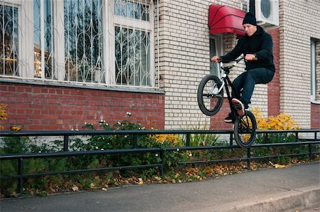 Biker doing icepick grind trick on low, black rail Stock Photo - Budget Royalty-Free & Subscription, Code: 400-05721355