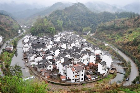 Landscape of a traditional Chinese village surrounded by a river and mountains Stock Photo - Budget Royalty-Free & Subscription, Code: 400-05721476