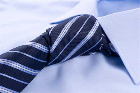 Tie knot tied on a blue shirt Stock Photo - Budget Royalty-Free & Subscription, Code: 400-05721547