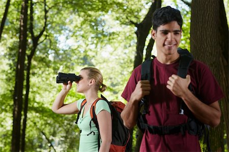 simsearch:400-06396994,k - young people trekking among trees and looking at birds with binoculars. Horizontal shape, side view, waist up Stock Photo - Budget Royalty-Free & Subscription, Code: 400-05721654