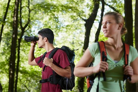 simsearch:400-06396994,k - young people trekking among trees and looking at birds with binoculars. Horizontal shape, side view, waist up Stock Photo - Budget Royalty-Free & Subscription, Code: 400-05721655