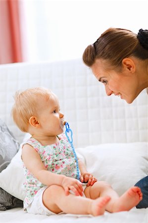 simsearch:400-05899075,k - Lovely baby and young mother playing on sofa at home Fotografie stock - Microstock e Abbonamento, Codice: 400-05723078