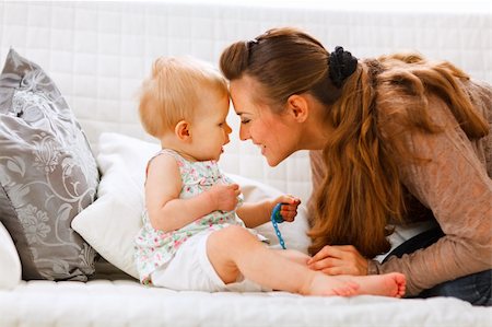 simsearch:400-05899075,k - Cute baby with soother and young mom playing on divan at home Fotografie stock - Microstock e Abbonamento, Codice: 400-05723080