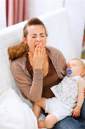 simsearch:400-05899075,k - Young mother with sleeping baby on hands yawing at home Fotografie stock - Microstock e Abbonamento, Codice: 400-05723093