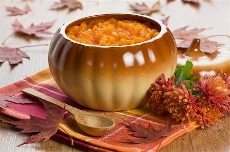 Pumpkin soup in ceramic pot, wooden spoon, flower and autumn leaf shallow DOF Fotografie stock - Microstock e Abbonamento, Codice: 400-05723565